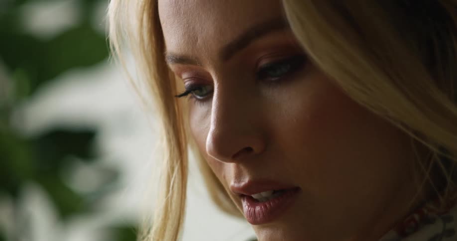 A woman is looking down and talking