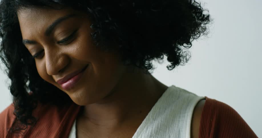 A woman is smiling inside a room