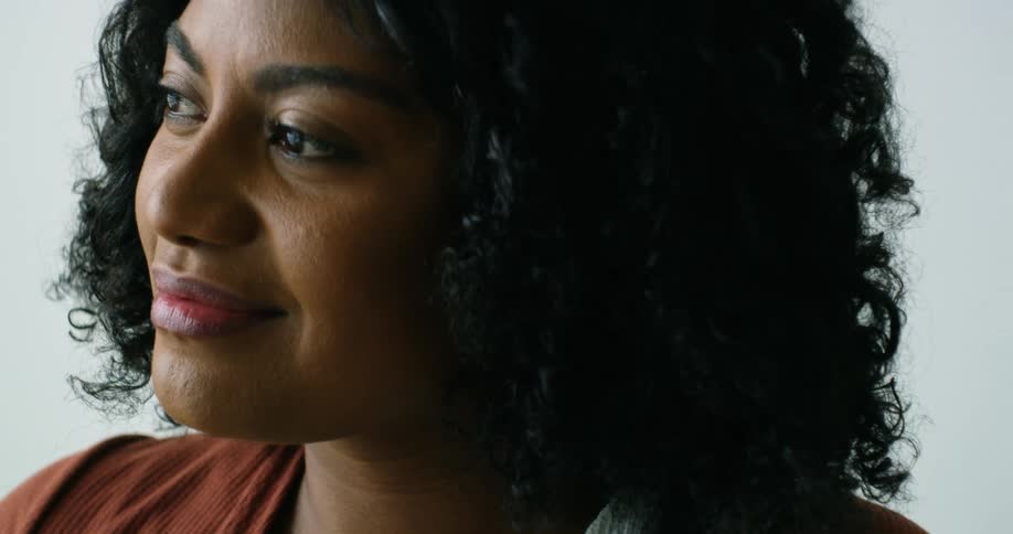 A woman is smiling while standing inside a room