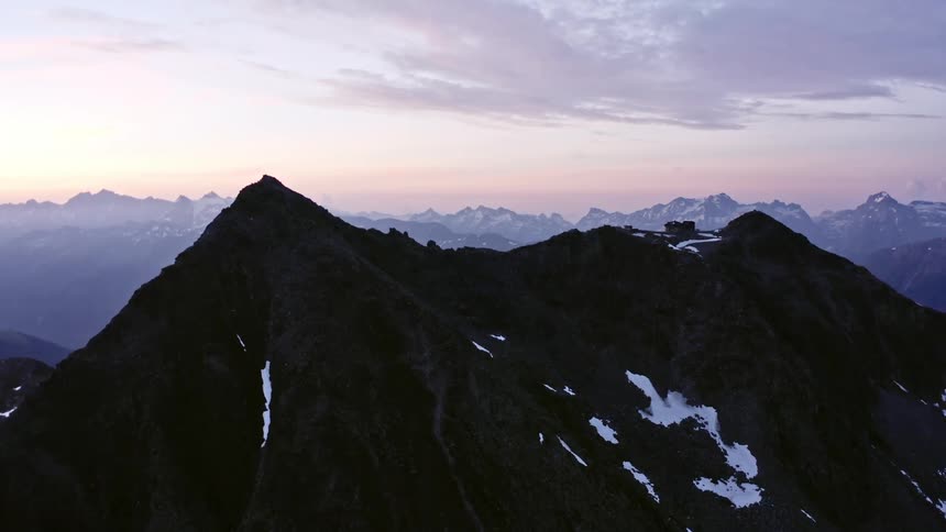 The sun is setting on the mountain range
