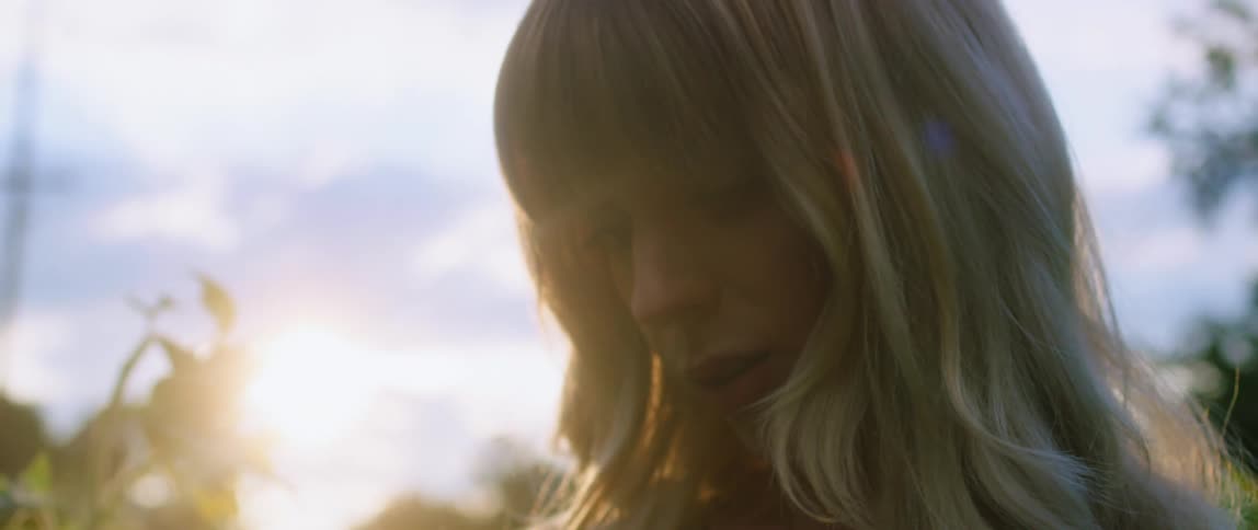 A woman looking at flowers