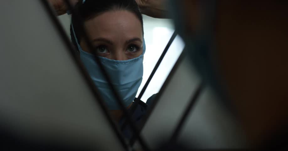 A nurse putting a mask on