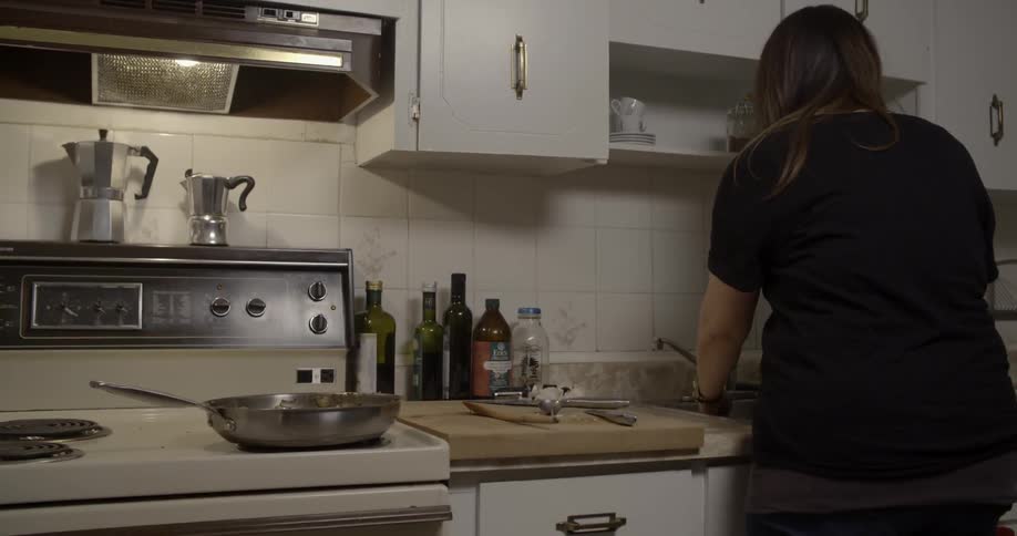 A woman is cooking in a kitchen