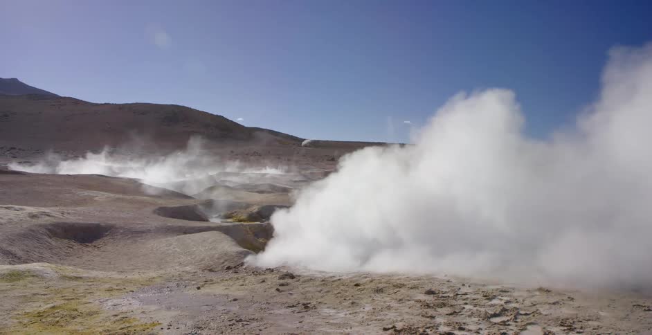 Steam billowing from a geyser in nature
