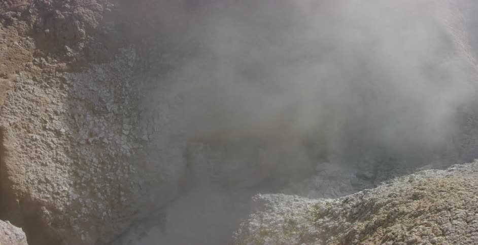 Water bubbling and steam rising in a geyser