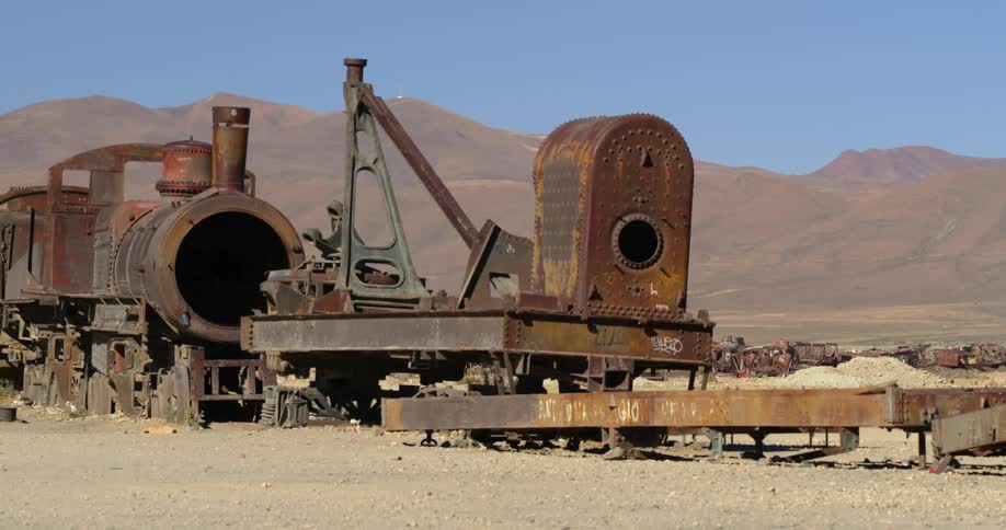 Rusty train wreck with train wagons in the desert