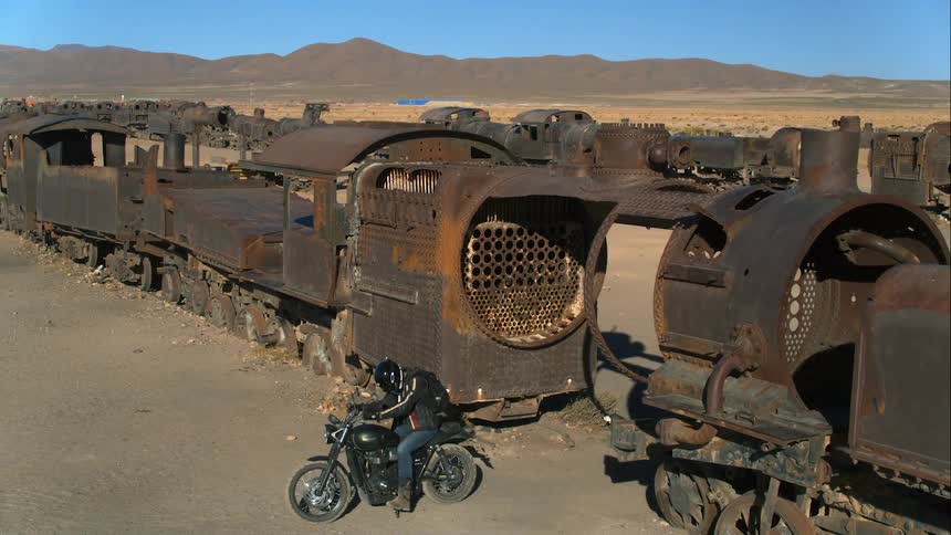 A man drives through the broken down train