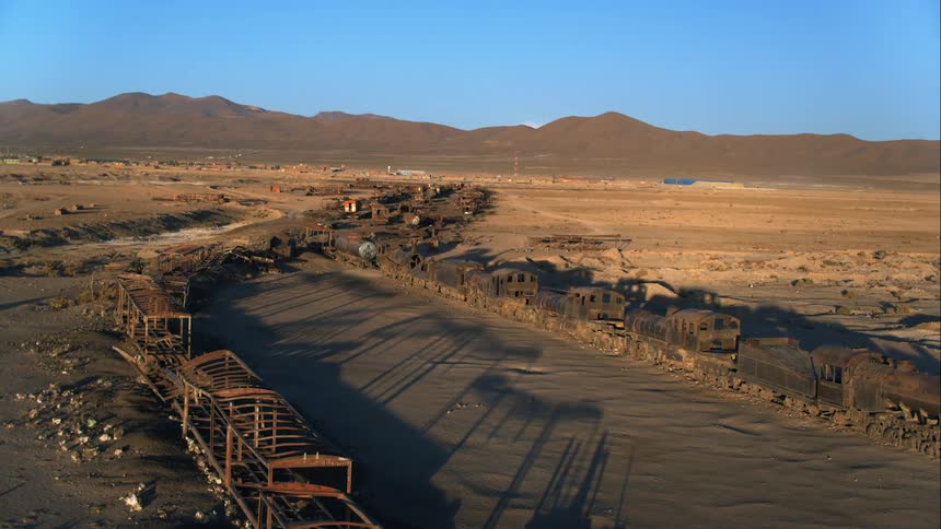 An abandoned old train in a desert area