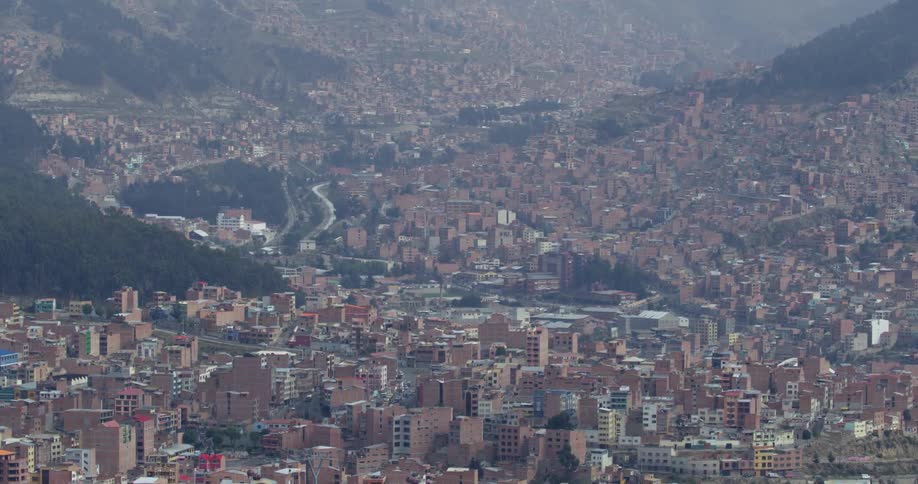 An aerial view of a city in front of the mountains