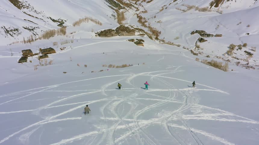 People skiing down a snow covered hill