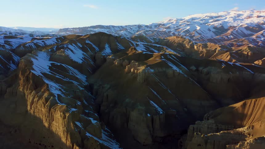 The sun is setting above the mountain range