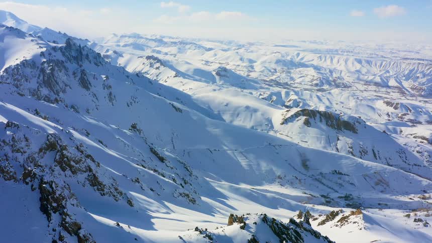 An aerial view of a snow covered mountain range