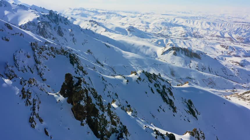 Snow covers the ridges on a mountain range
