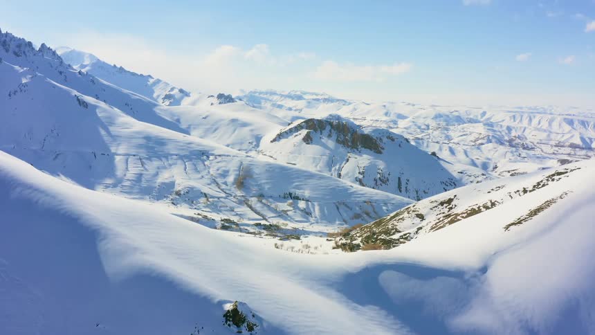 A snow covered mountain and valley range