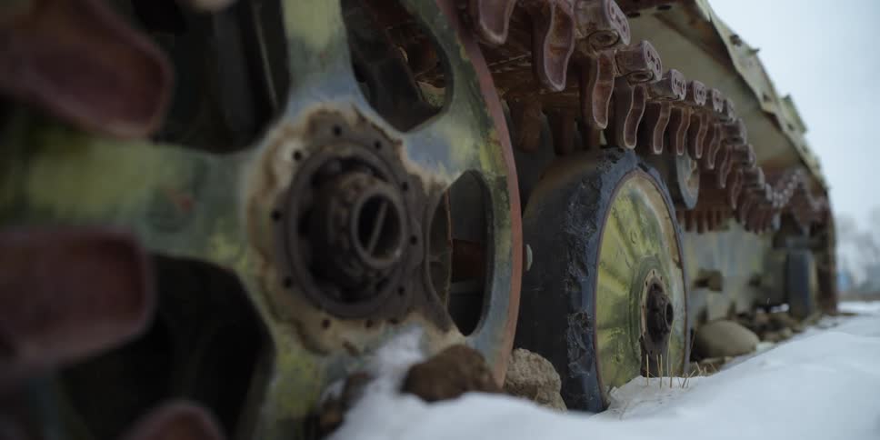 The continuous track on a tank in a field of snow on a snowy winter day