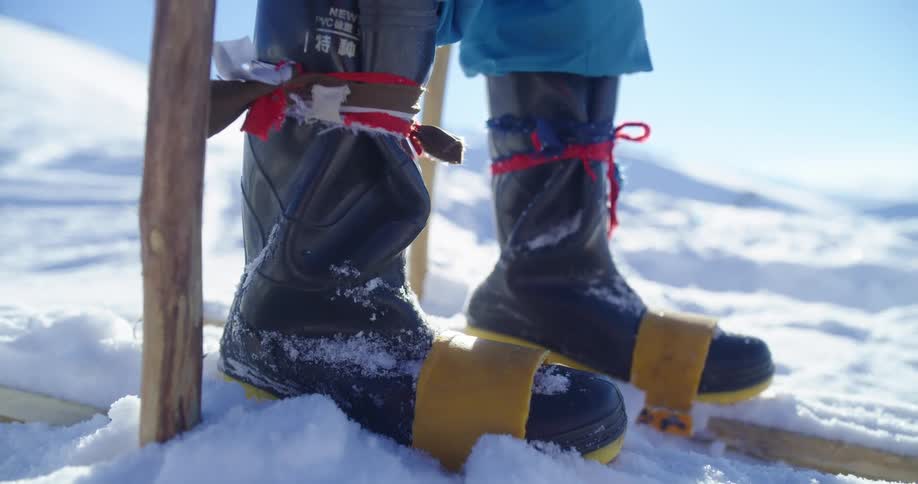 A person is standing on the snow covered slope