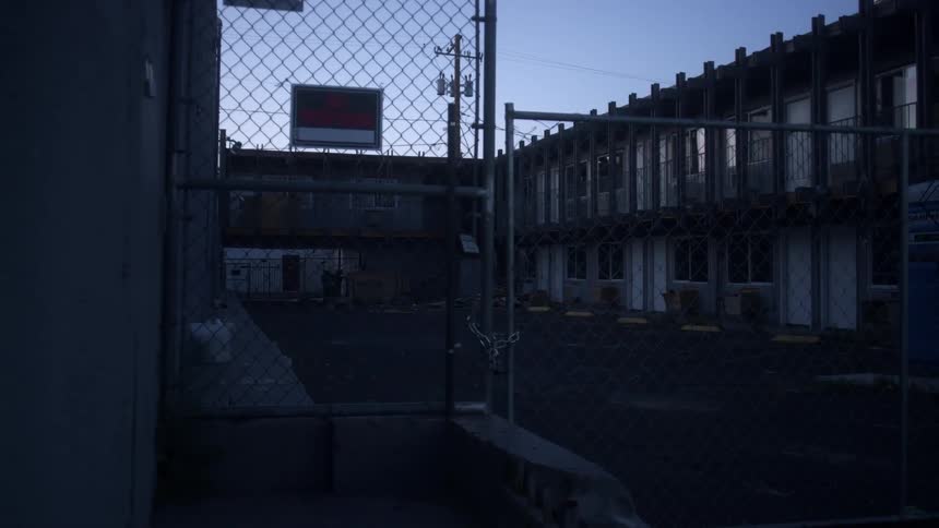 An apartment complex with a lock on the fence