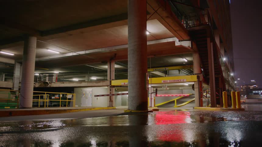 It is raining outside of the parking garage