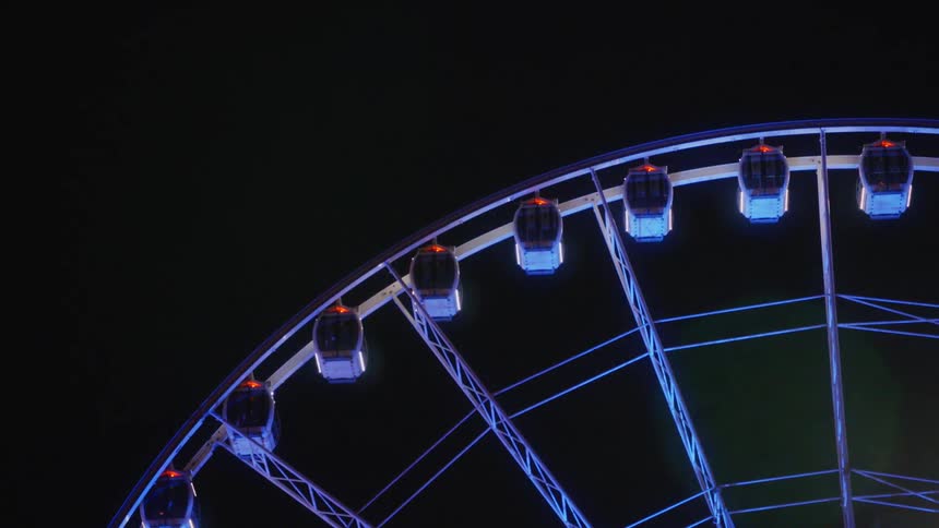 Ferris wheel with blue lights at night