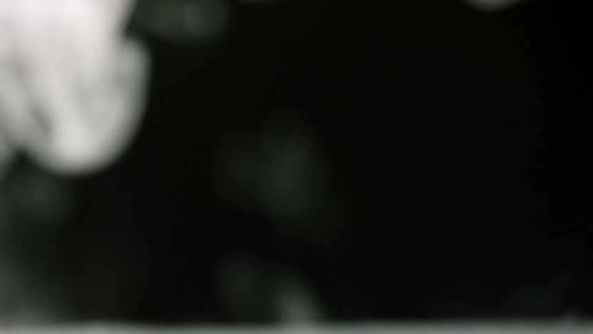 White smoke billowing in front of a black background