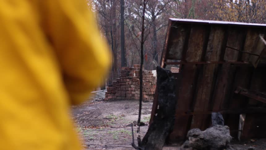 A large stack of bricks sit in the yard