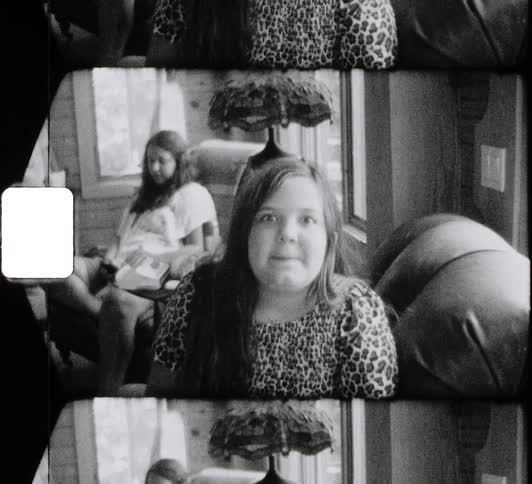 A child is sitting on the chair staring forward