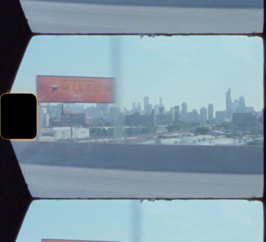 A city skyline with buildings and trees with the sky and clouds in the background 8mm