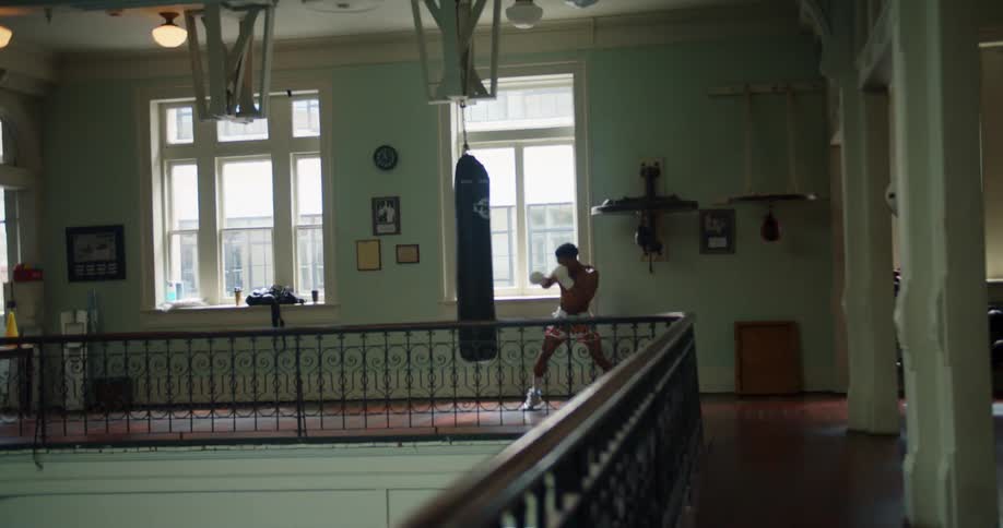 A man boxes with a punching bag