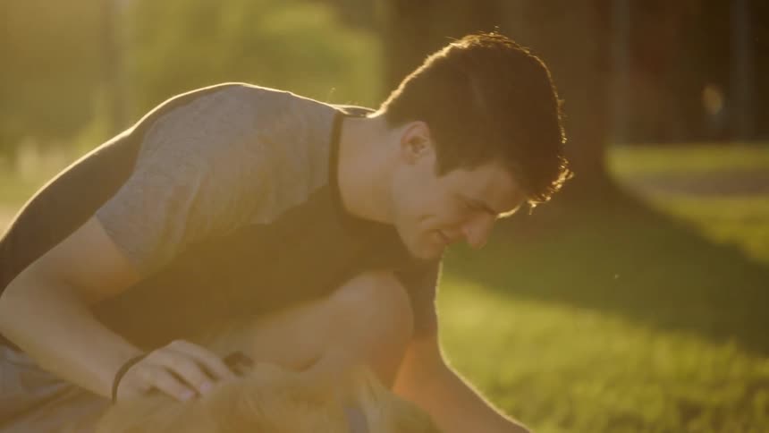 A couple and their dog set up for a picnic