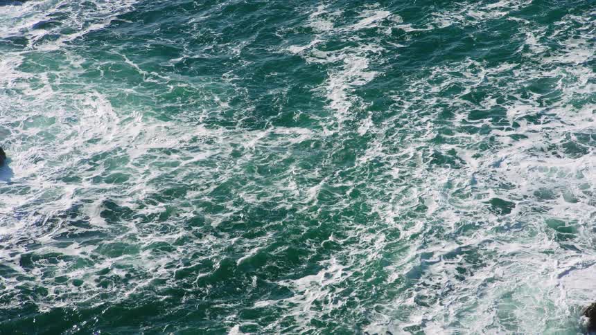 An aerial view of an ocean is displayed