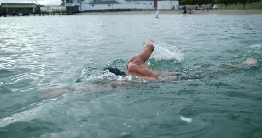 A man is swimming in the ocean