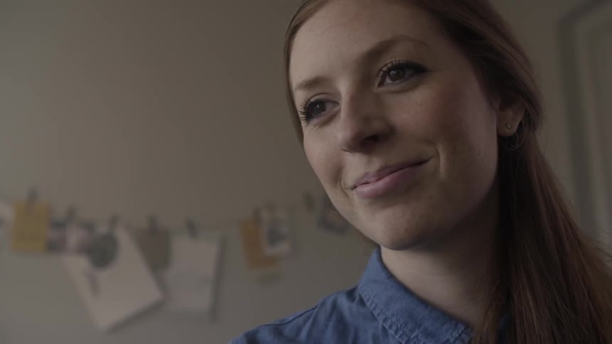 A woman in a blue shirt smiles