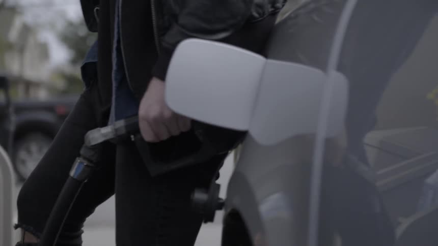 Man putting gas into his car