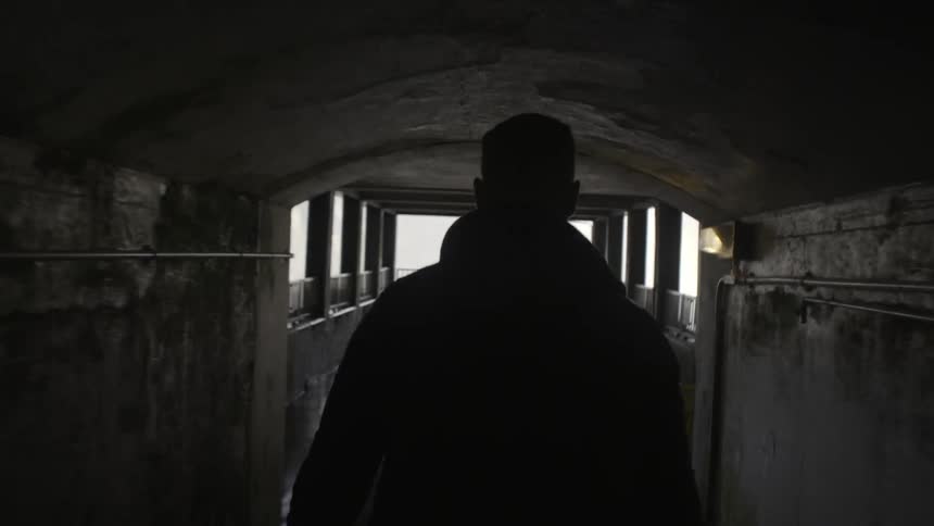 A man walks through a dark building