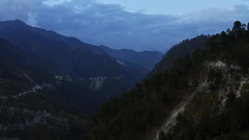 Clouds floating above mountains in the wilderness