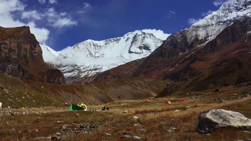 People are camping by the mountain