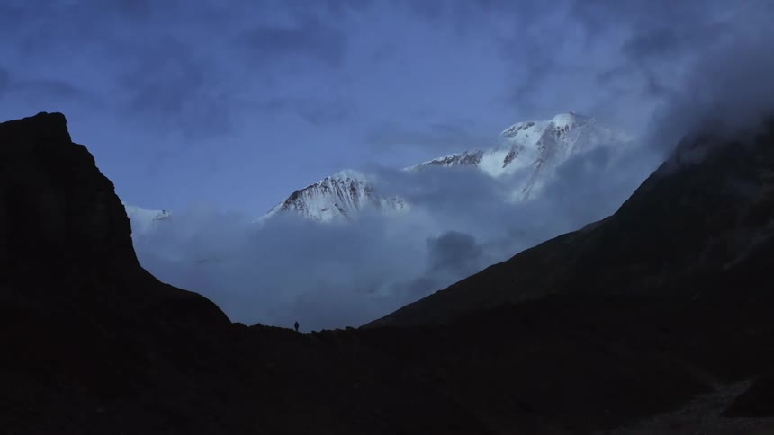 Aerial view of mountains is displayed while the sun is setting