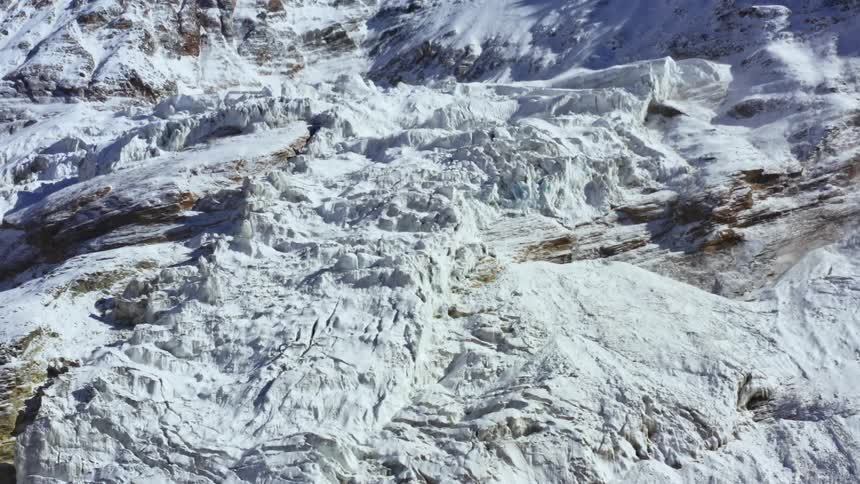 Large sections of compacted snow on a mountain during the day