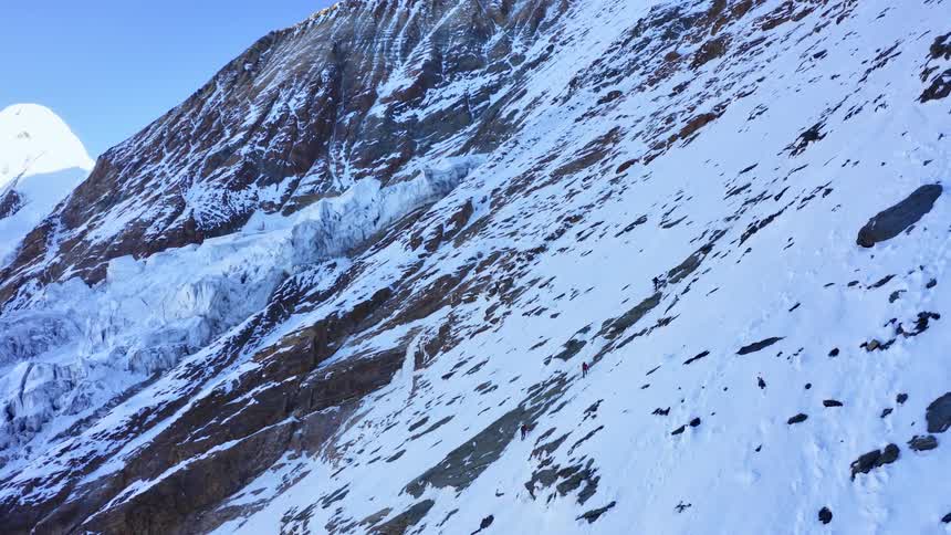 Aerial view of snow covered mountains is displayed