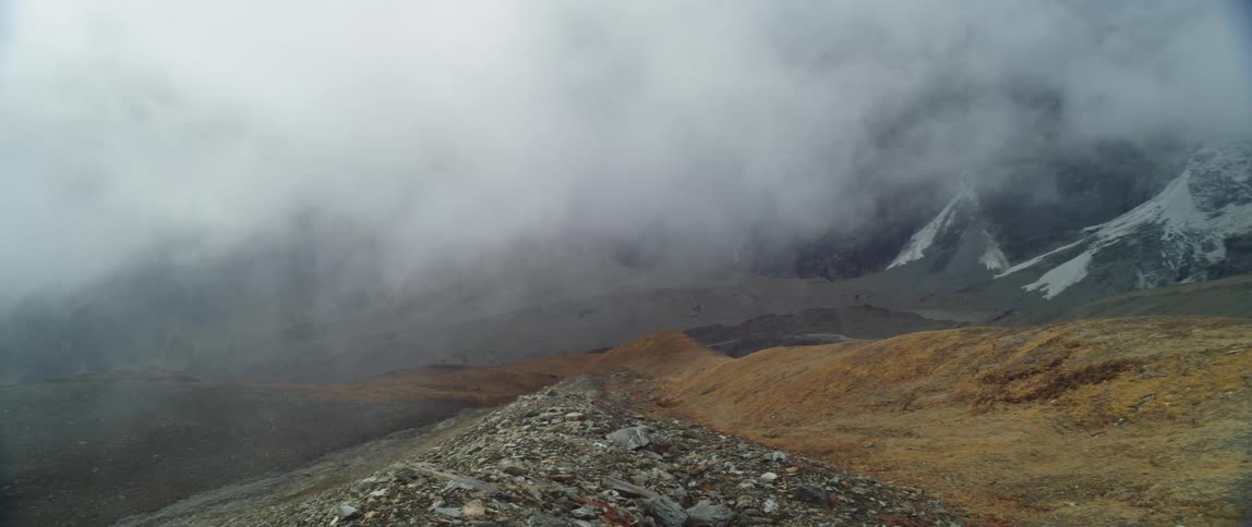 Steam on a mountain range and grassy area