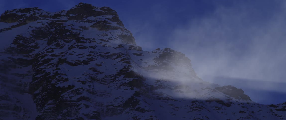 Steam coming off a snowy mountain top