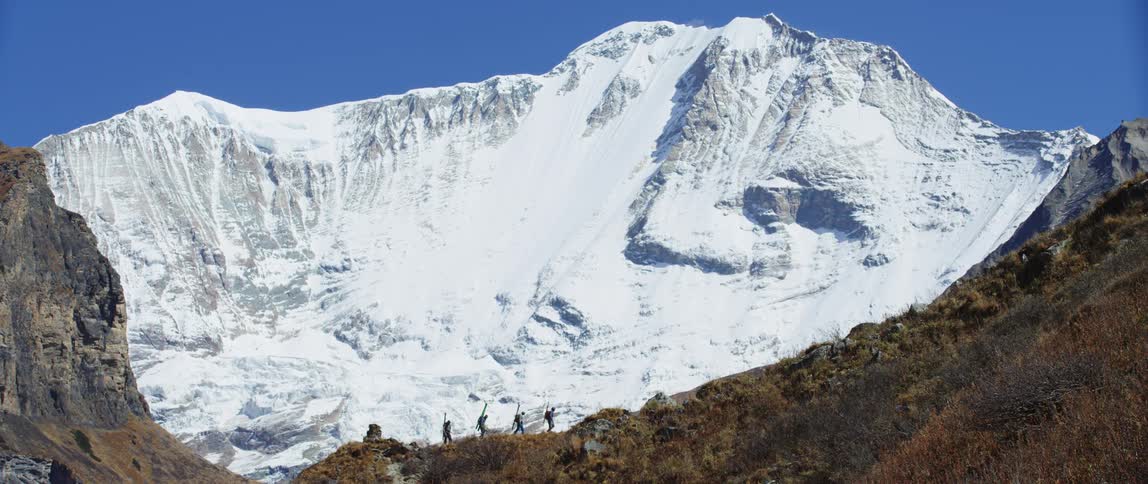People are walking near the mountain