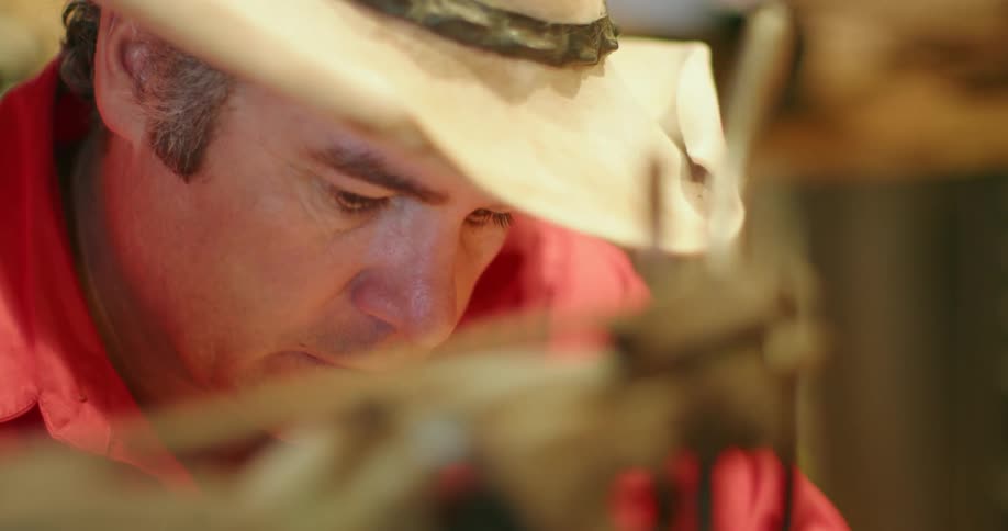 A man sewing at a sewing machine