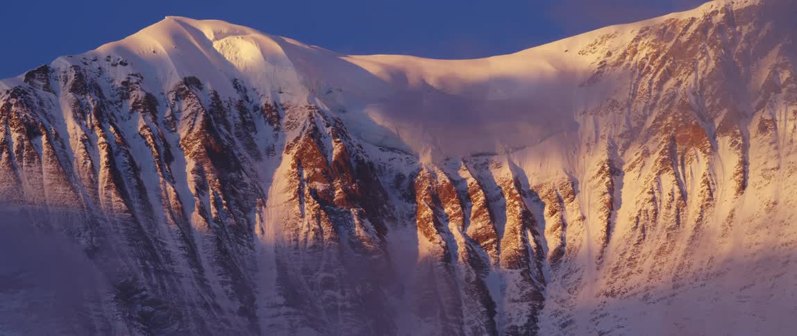 A snow covered mountain range on a winter day