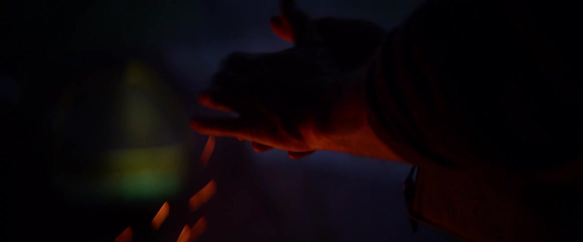 A person with their hands over a fire