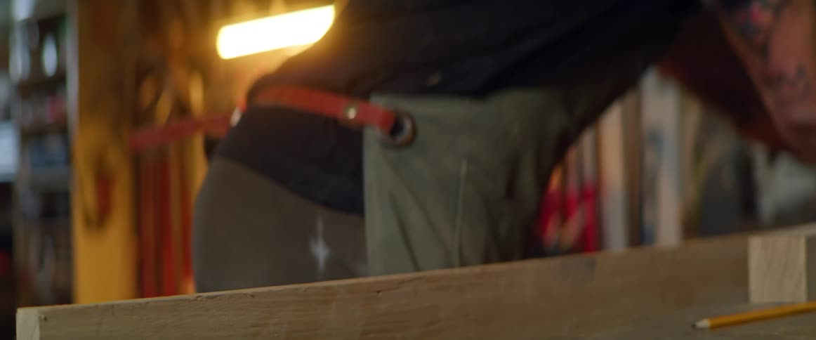 Man planing wood in workshop