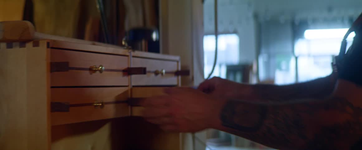 A man looks through a toolbox in his garage