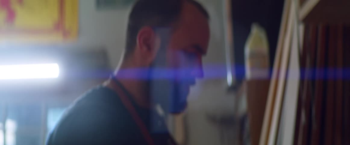 A man looks through multiple tool box drawers trying to find something