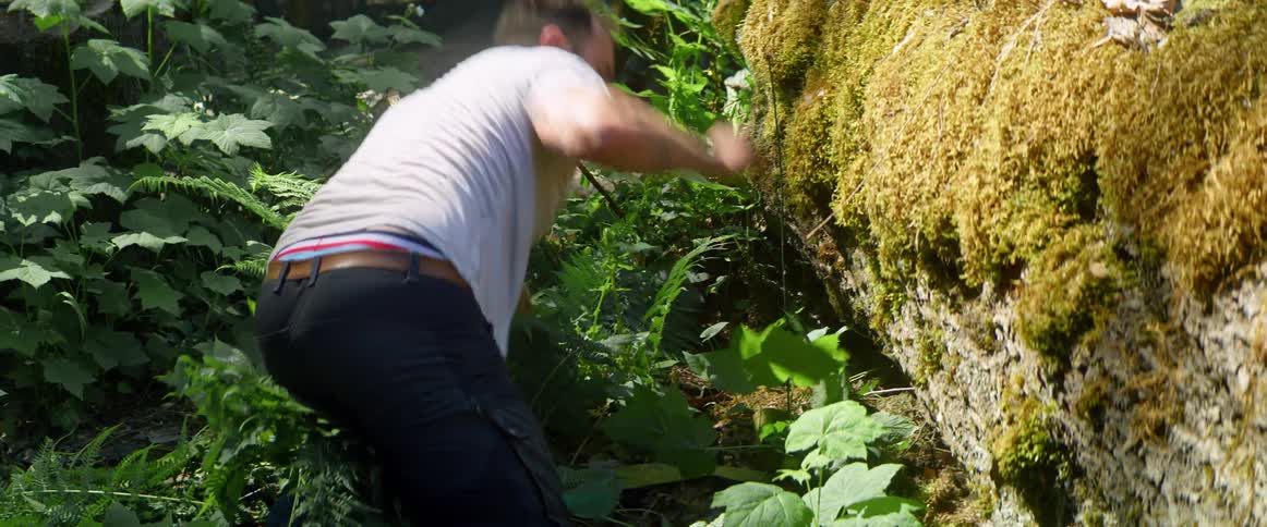 A man digs under a fallen tree