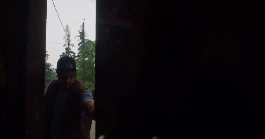 A man opens a door to a company shop and enters